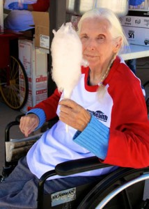 Rhonda Shears , a resident of E. Dene Moore Care Center, enjoys some cotton candy at the Vintage Base Ball game.